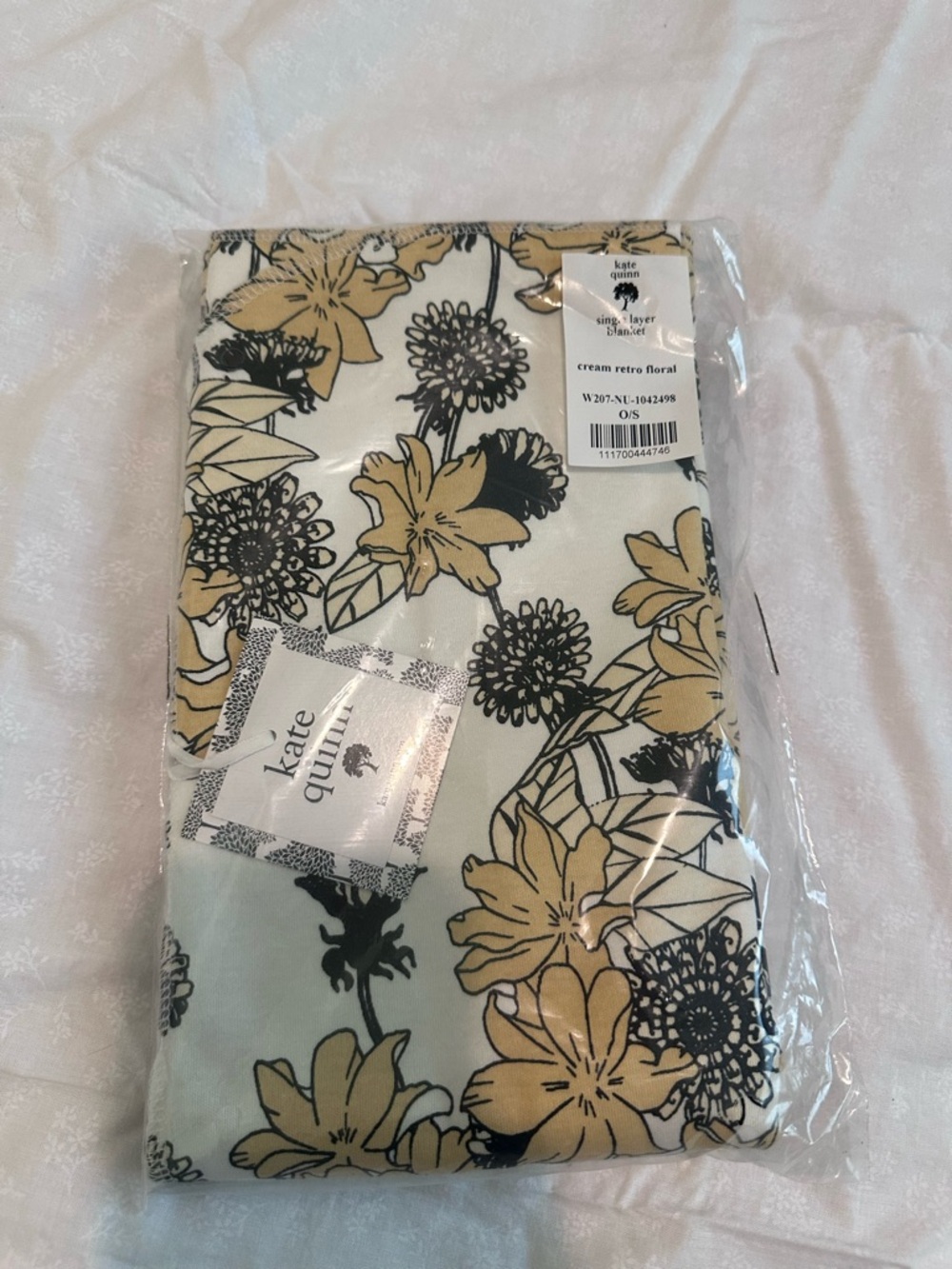 kate quinn cream floral swaddle with black and cream print